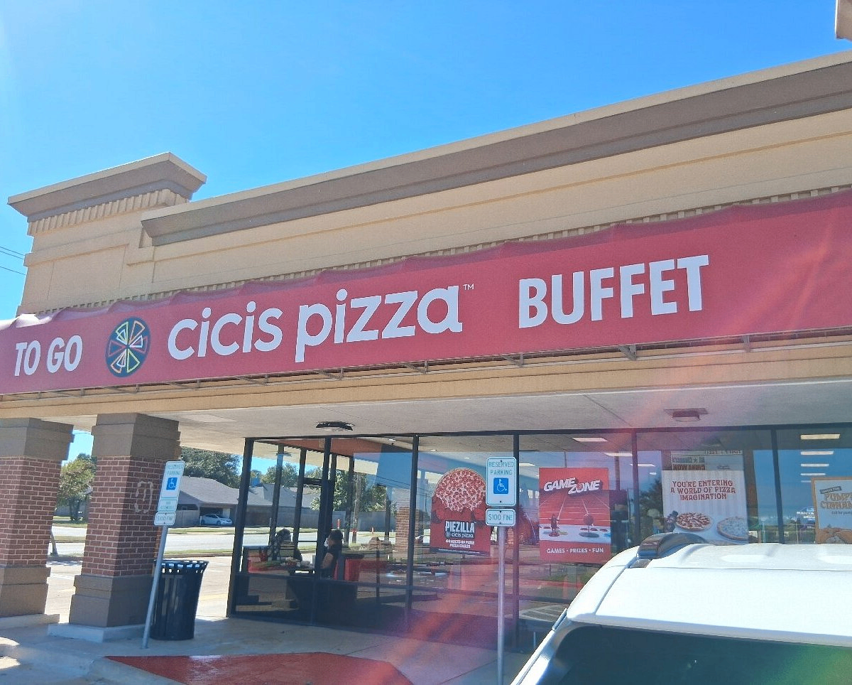 Before: a dark, everyday pizzeria storefront photo